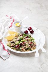 Quinoa salad with cherries, celery and cucumbers, selective focus