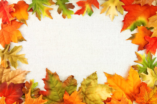 Thanksgiving & Autumn design element - silk leaves fall colors on canvas tweed background with copy space.  