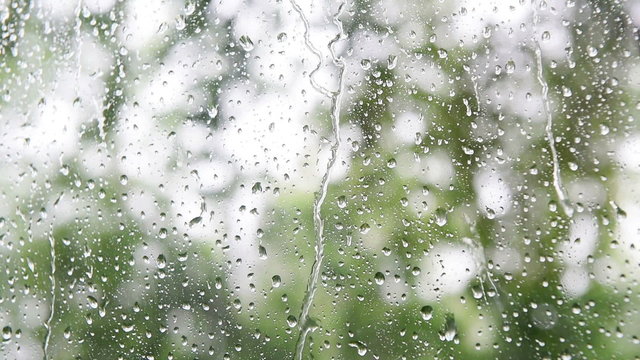 Close up image of rain drops falling on a window 