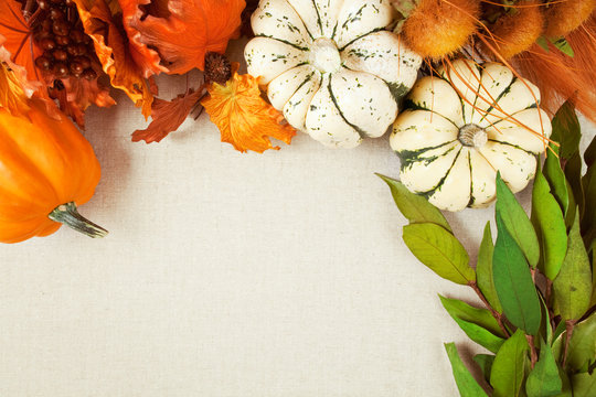 Thanksgiving & Fall Background. Pumpkin squash and autumn silk florals on canvas style background. Room for copy space. 