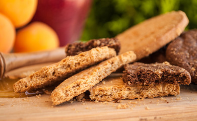 biscuits with honey and honey dipper with milk and fruits
