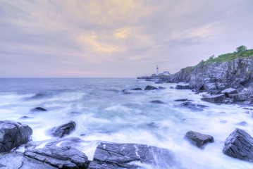 Fototapeta na wymiar Portland Head Lamp and rocky Maine coastline