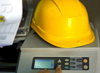 engineer using plotter for  technical drawing. Focus is on the finger
