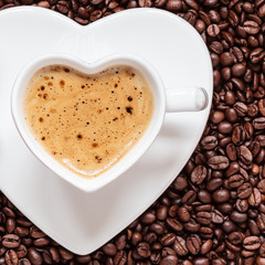 white coffee cup heart shaped with cappucino
