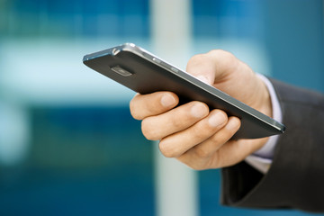 Business Man Typing With Finger On Phablet Smartphone