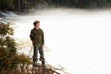 boy by a misty lake