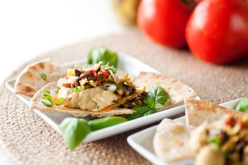 Olive Bruschetta, Hummus Dip on Toasted Pita Wedges, fresh tomatoes spring onions and basil. 