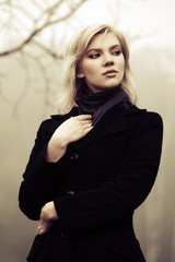 Young fashion woman in autumn morning fog