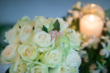 Candle and Wedding bouquet of white roses