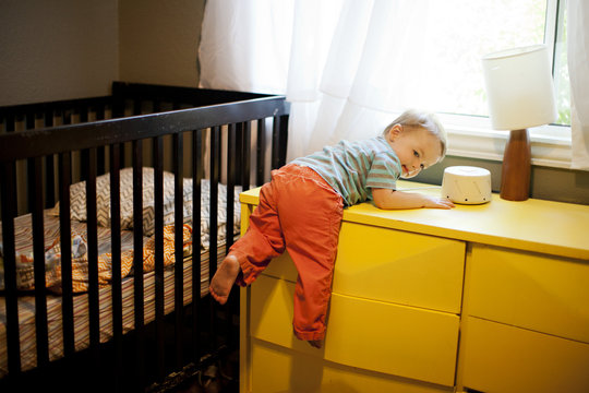 Little Boy Climbing On His Dresser