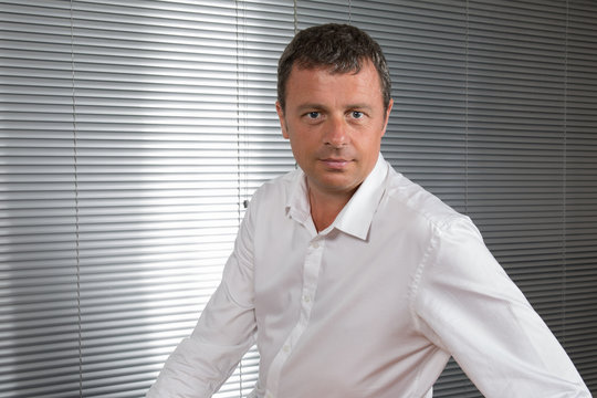 Attractive And Confident Business Man Smiling At Office