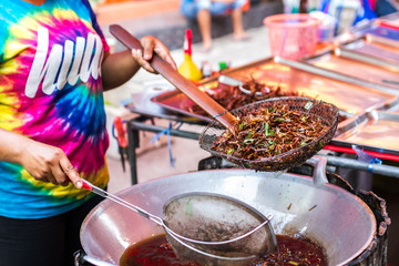 frying grasshoppers at market