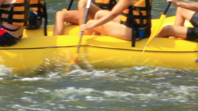 Yellow boat with rowing people. Rafting team, 50 slow speed