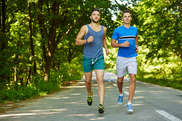 Friends running through forest