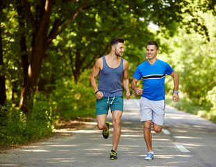 Friends running through forest