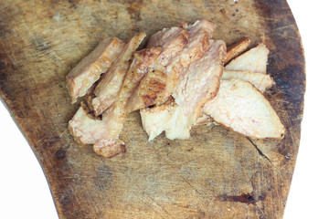 Sliced grilled pork chop on a wooden board