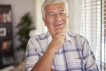 Cheerful senior man in his living room