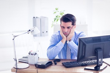 Sad businessman sitting at his desk