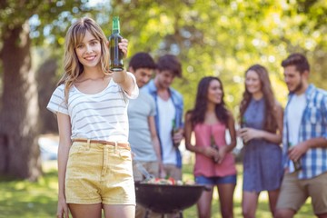 Happy friends in the park having barbecue
