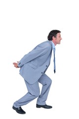Businessman carrying something with his back and hands