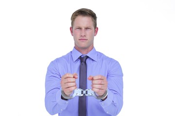 Handsome businessman wearing handcuffs