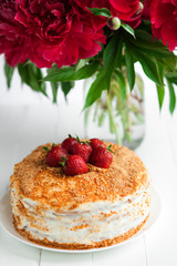 Sweet cake with strawberry on table