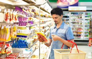man in a supermarket buying sliced bacon
