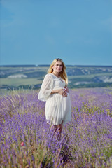 Fototapeta na wymiar pregnant woman in a lavender field