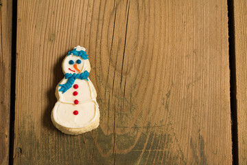 Christmas cookie on picnic table/Sweet snowman cookie on wooden table