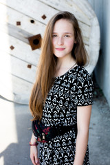 Fototapeta premium portrait of cool young and beautiful caucasian blonde teenager hipster girl with long gorgeous hair is posing smiling and having fun