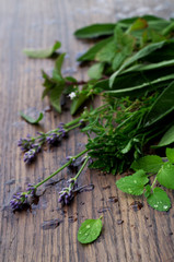 Bunch of fresh organic herbs on rustic wooden background
