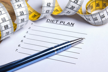 paper with diet plan, pen and measure tape