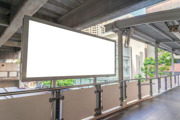 large blank billboard on overpass with city view background