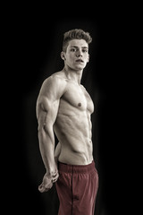 Fototapeta na wymiar Handsome young bodybuilder in triceps pose