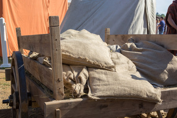 wooden cart with straw and sacks