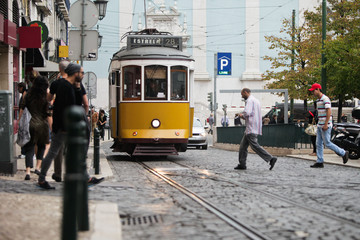 Old yellow tram on busy street