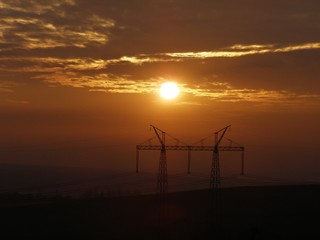 Obraz premium Electric pillar.Electric pylons at sunset.