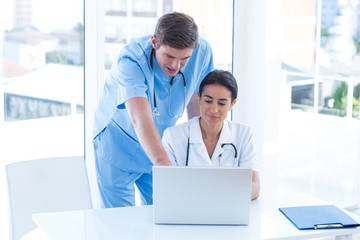 Team of doctors working on laptop