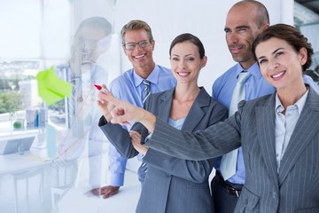 Businesswoman drawing graph on the board