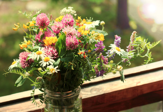 Wild flowers at a window - retro photo