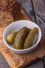 Pickled cucumbers in white bowl