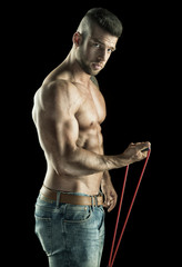 Man with rope During training, muscular body on black