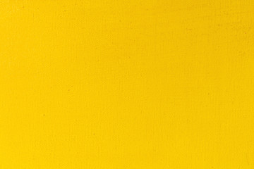 Abstract yellow texture on canvas close-up