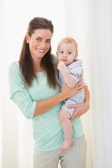Happy mother holding baby boy