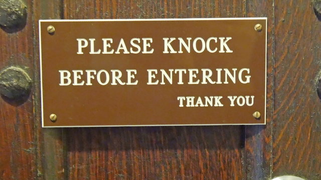 A signage on the door saying knock first before entering the premises