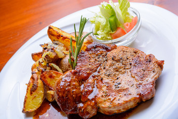 Grilled steak with roasted potatoes and salad