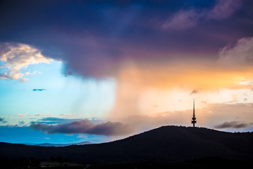 Rain clouds accumulated behind the Black Mountain in Canberra, Australia in the morning - obrazy, fototapety, plakaty