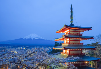 Mountain Fuji and red pagoda evening light up in cherry blossom sakura season