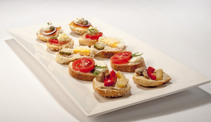 Mini sandwiches - bread with cream cheese, smoked salmon, and vegetables
