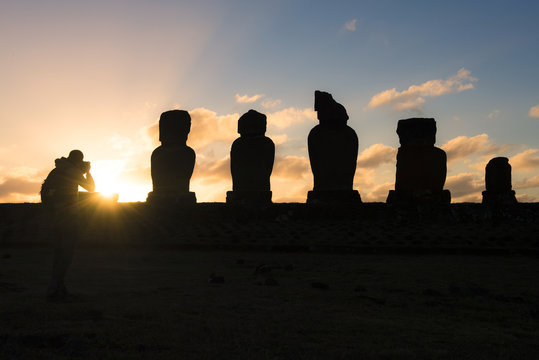 Chile, Easter Island, Man taking pictures of Moais at sunset, Ahu Tahai Complex, Rapa Nui National Park